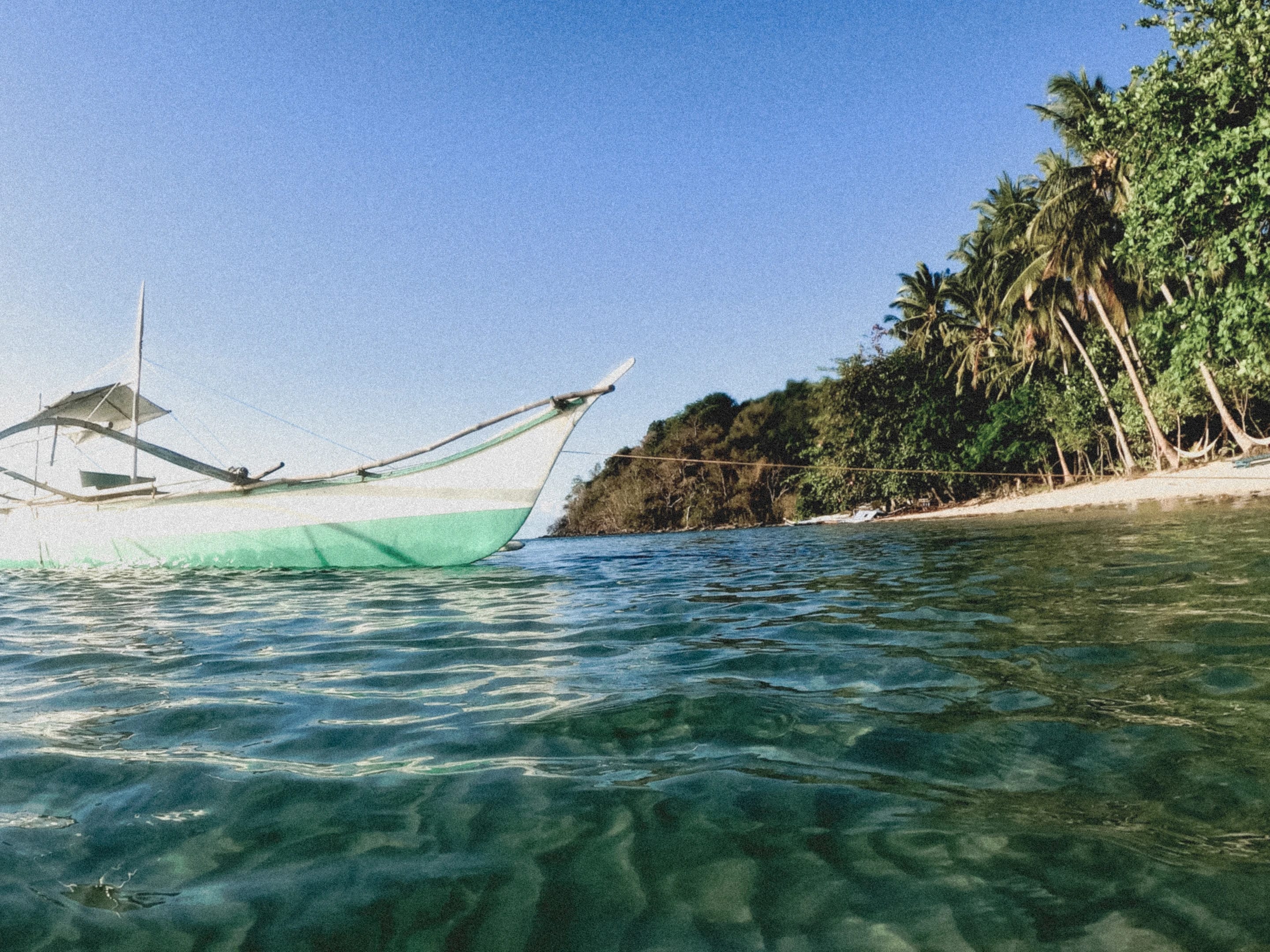 Half underwater beside an outrigger